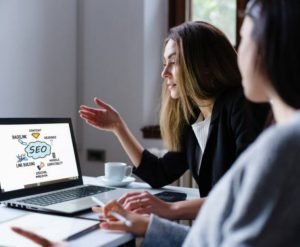 Young women Discussing plan with colleague