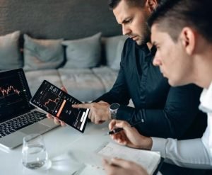 Man in Black Long Sleeve Shirt Holding Black Tablet Computer